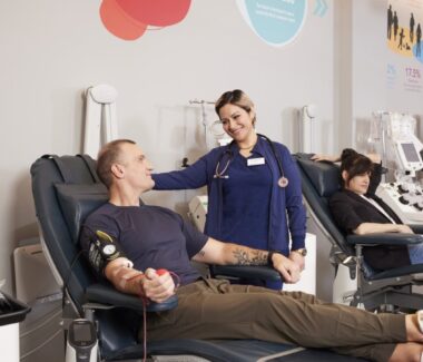 Smiling phlebotomist attending to a blood donor at CBC doner center.